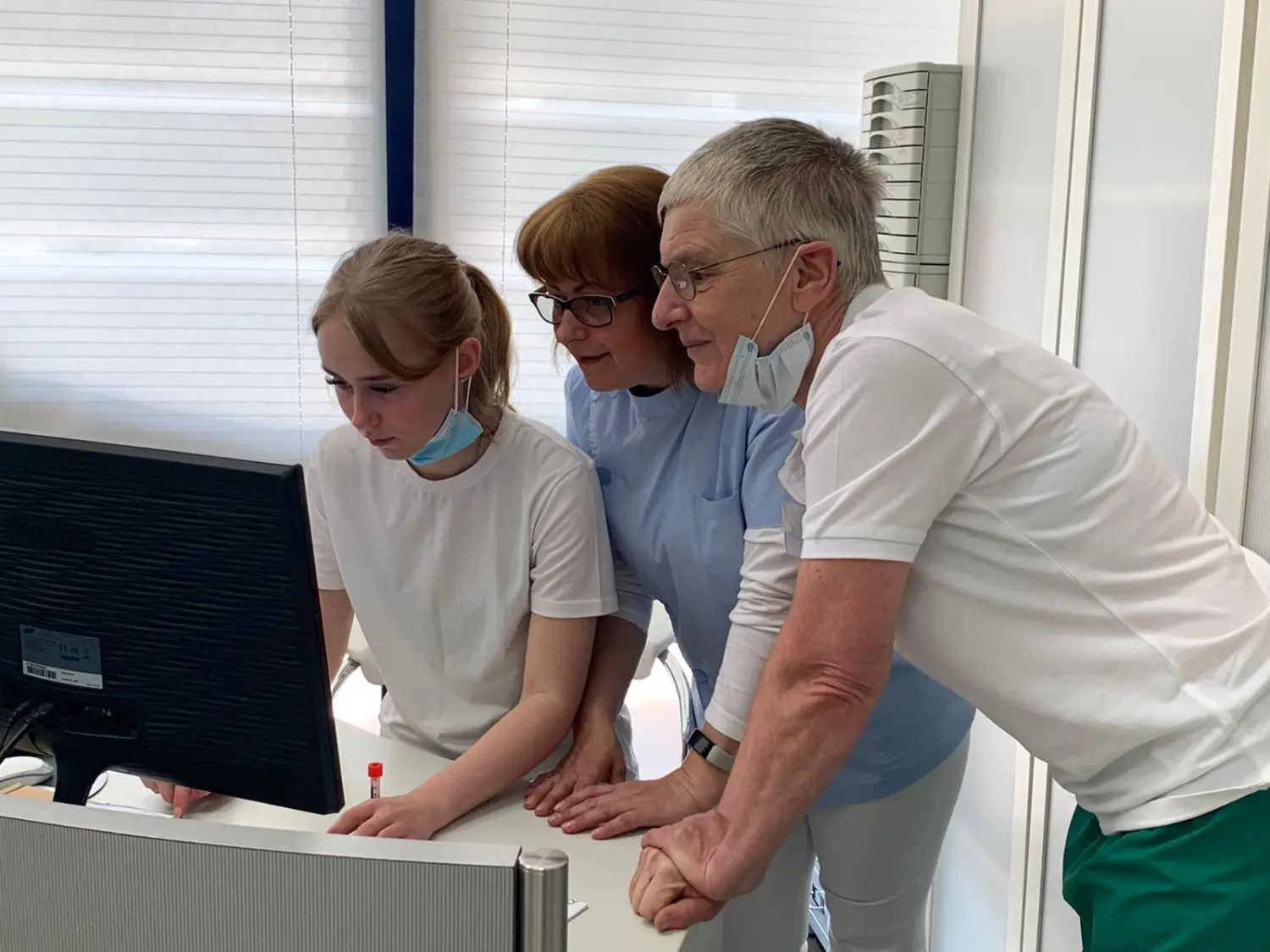 Veterinärpersonal blickt auf einen Monitor